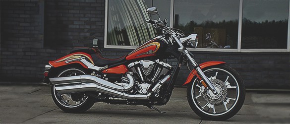 A glossy steel Yamaha cruiser with red and gold detailing